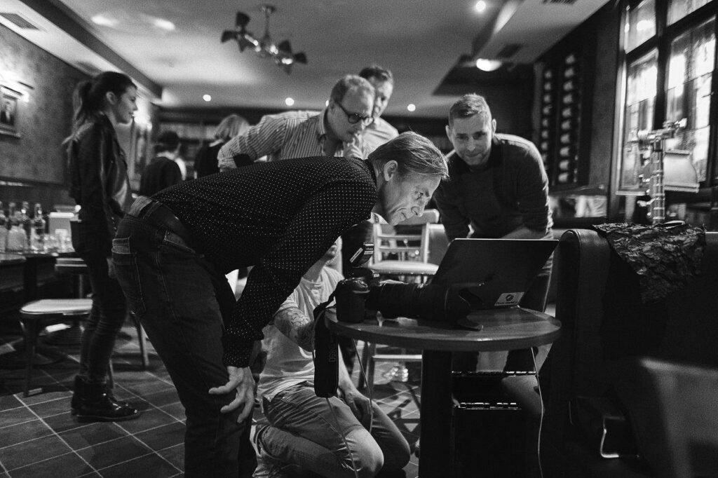 Client and photography team reviewing images together during a commercial photography shoot