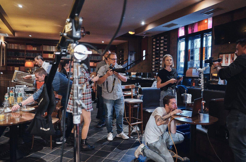 Photo production crew and clients working with camera equipment during an on-location commercial shoot