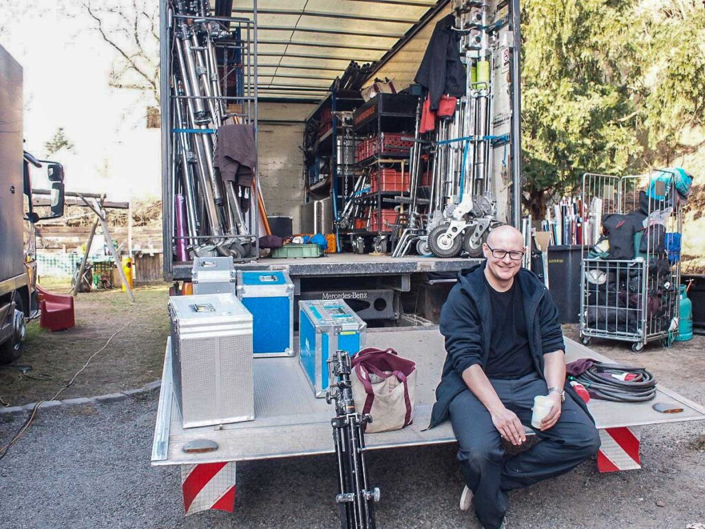 Photographer with production equipment during an outdoor commercial photography shoot
